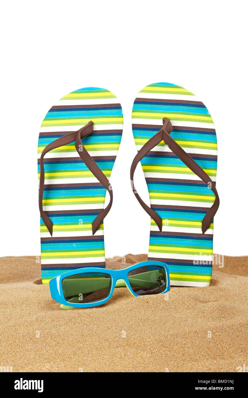 A pair of flipflops or beach sandals and sunglasses with copy space on ...