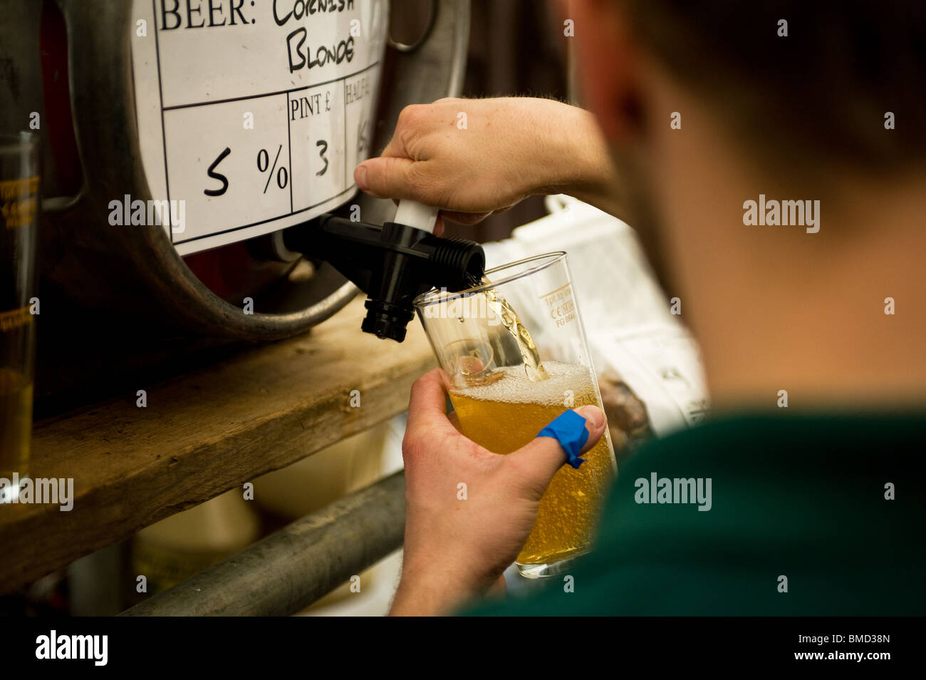 A bar worker pouring a pint of real ale at the Hoop Beer Festival in Essex Stock Photo