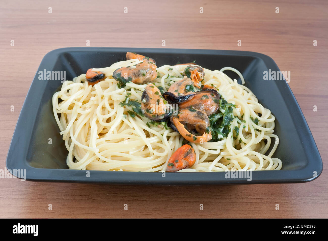 typical italian cooking spaghetti with mussels and garlic Stock Photo Alamy