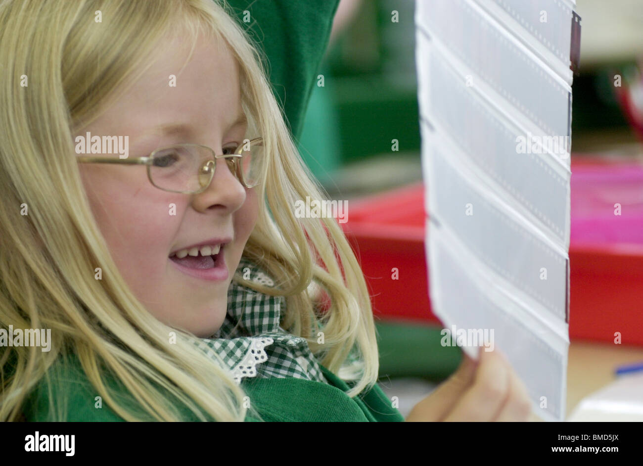 A young girl looks at some photographic negatives UK Stock Photo Alamy