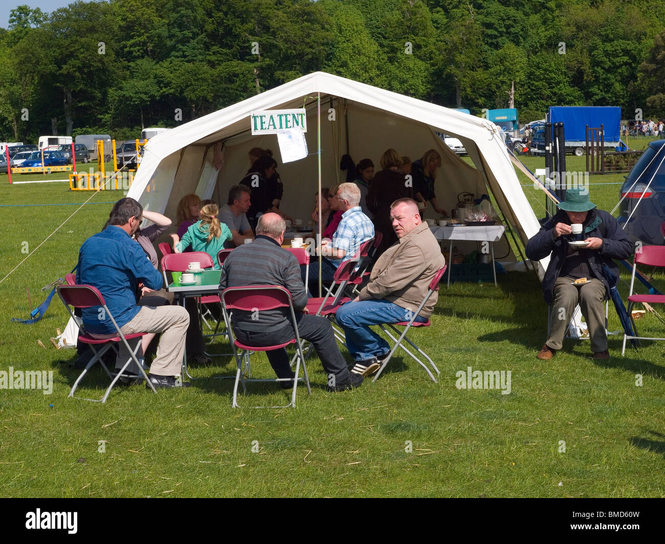 People enjoying refreshments in the tea tent at a country fair North