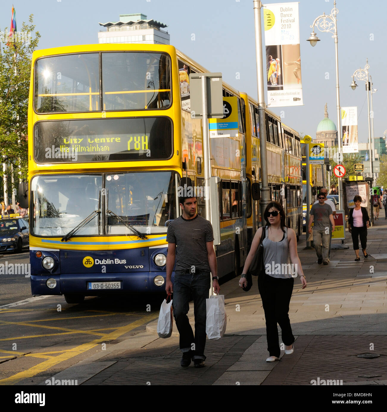 Yellow and Blue painted Dublin buses on Aston Quay in Dublin Ireland