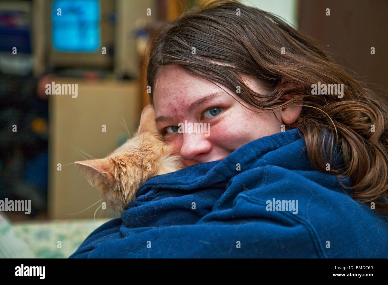 Thirteen year old teenager wearing denim jacket holding ginger