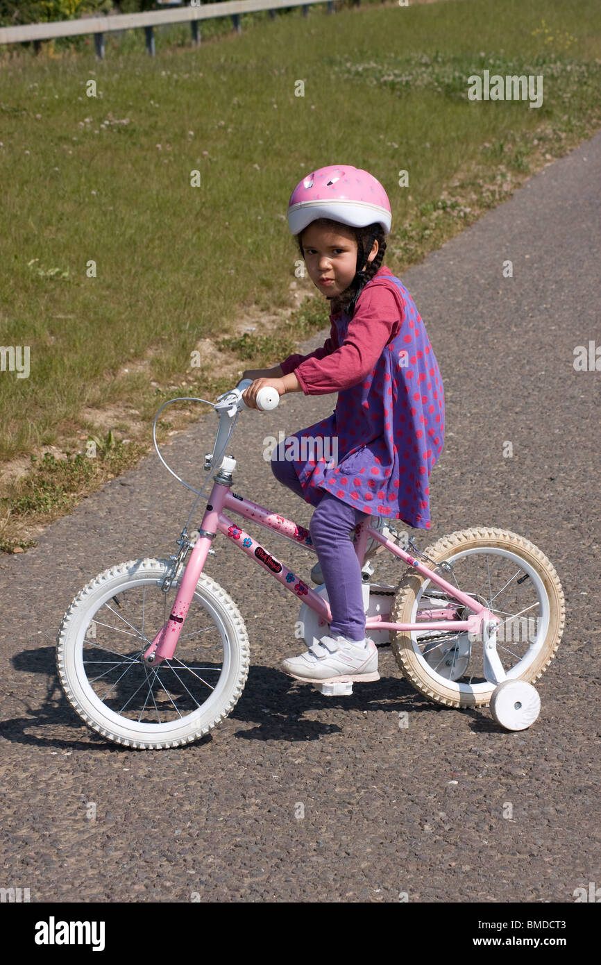 healthy lifestyle black ethnic girl cycling in the countryside Stock Photo