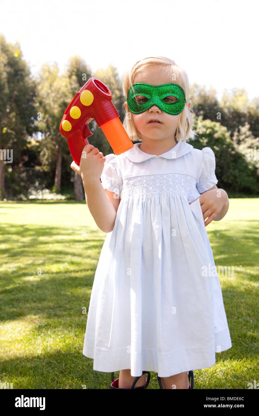 Young girl in mask with bubble gun Stock Photo