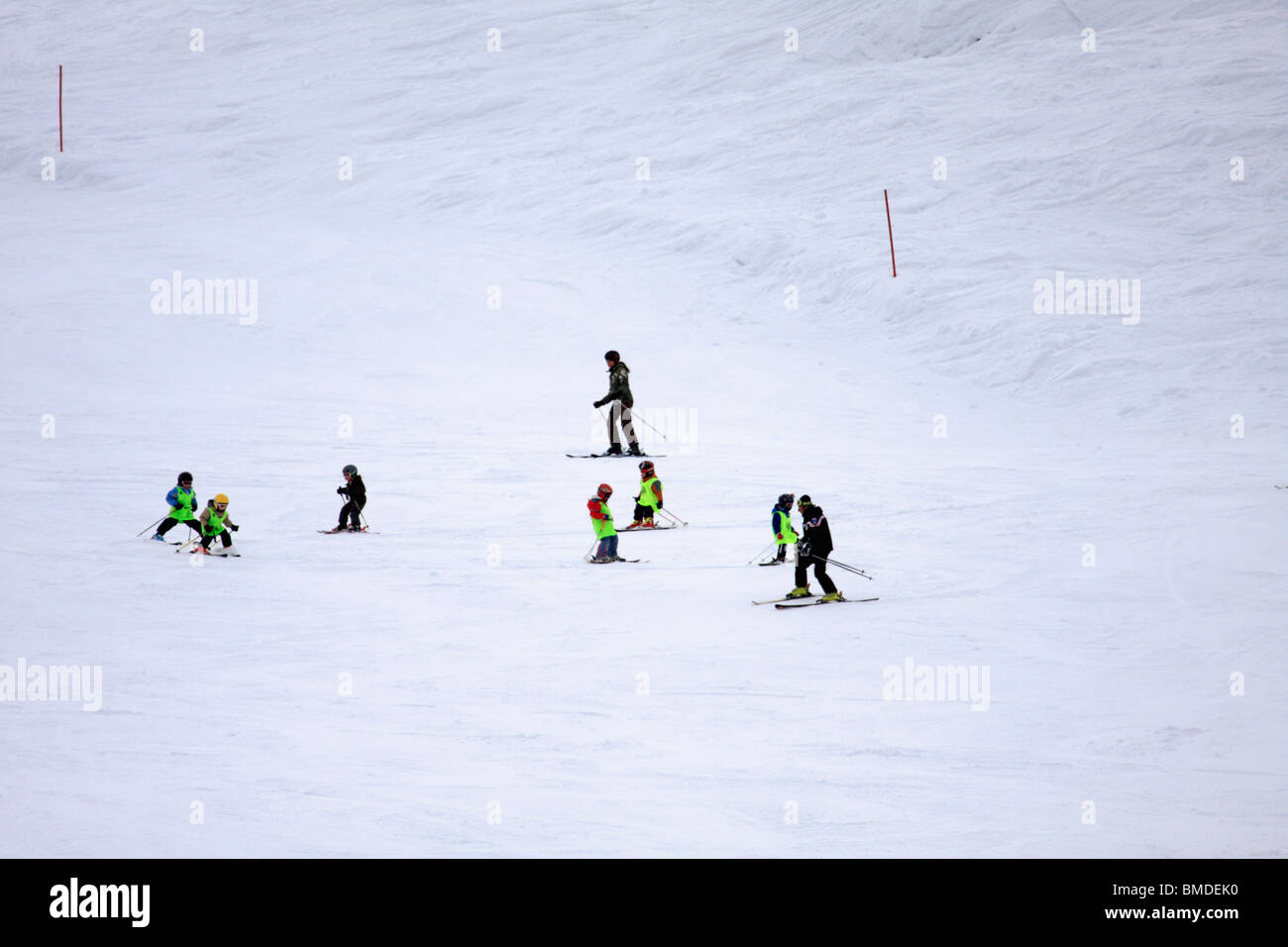 Young children and instructors in ski class, Alpe Mera, Italy Stock Photo