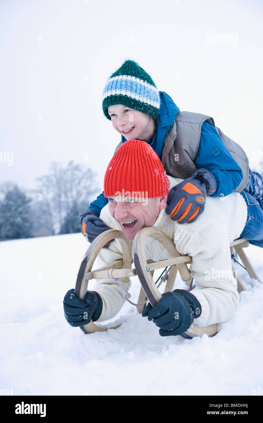 Father and Son Tobogganing Stock Photo