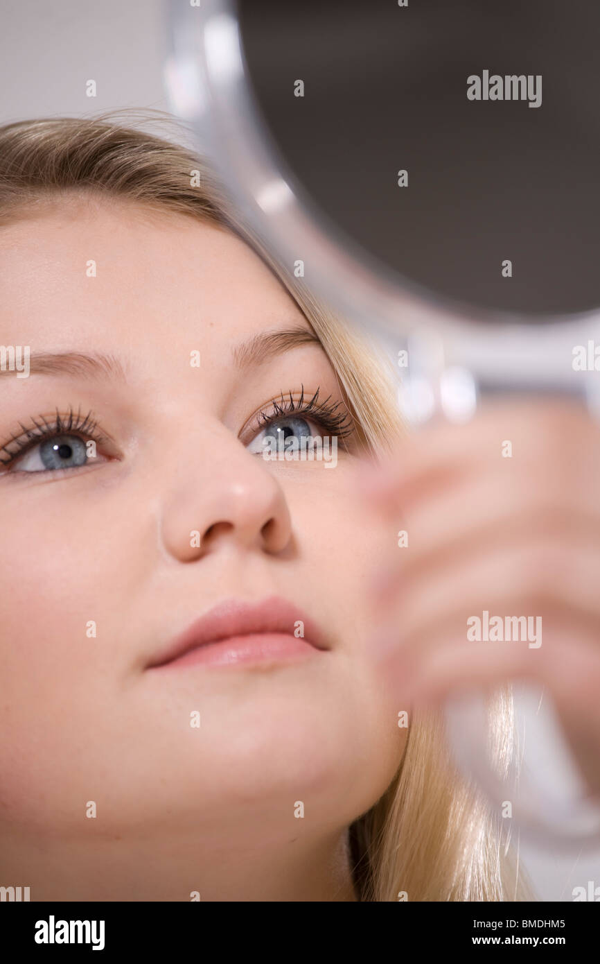 Close-Up of Woman Holding Mirror Stock Photo