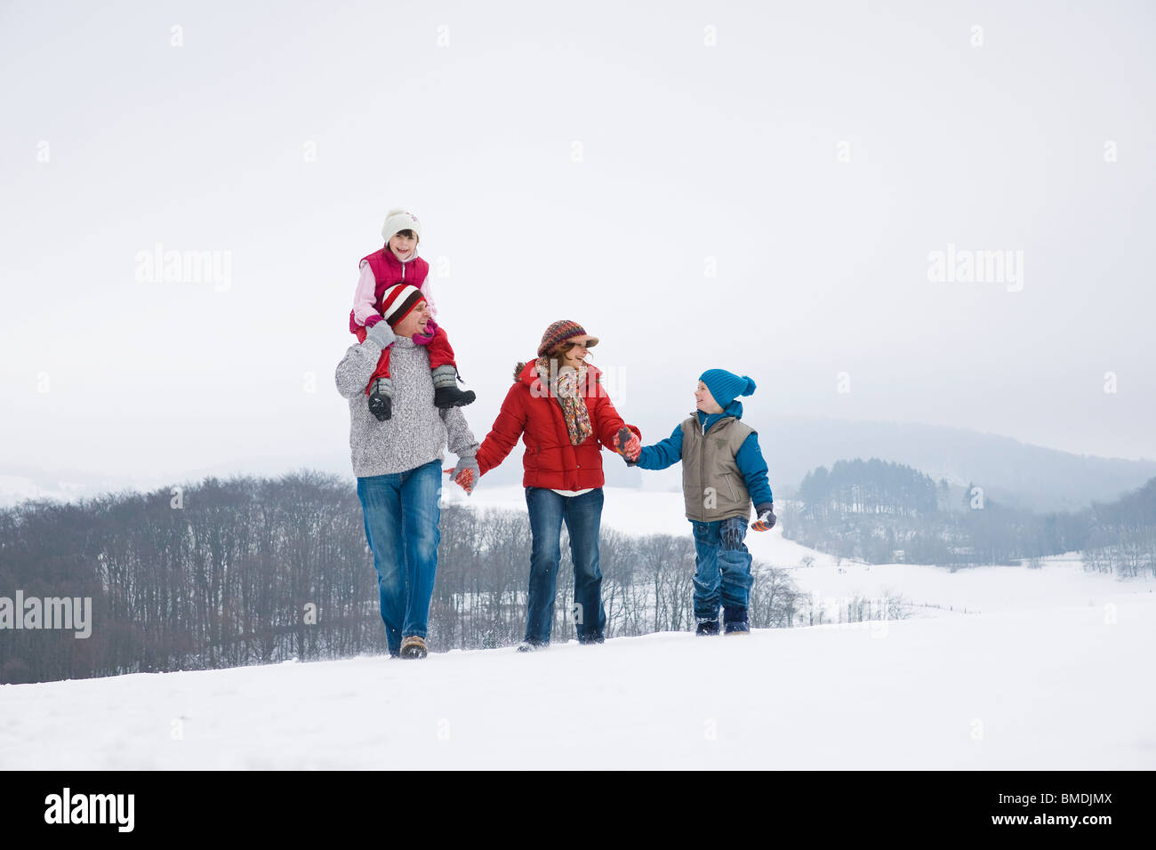 Family Walking in the Snow Stock Photo - Alamy
