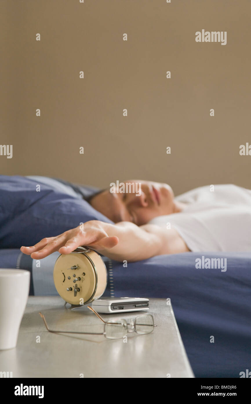 Sleeping Man Turning Off Alarm Clock Stock Photo Alamy