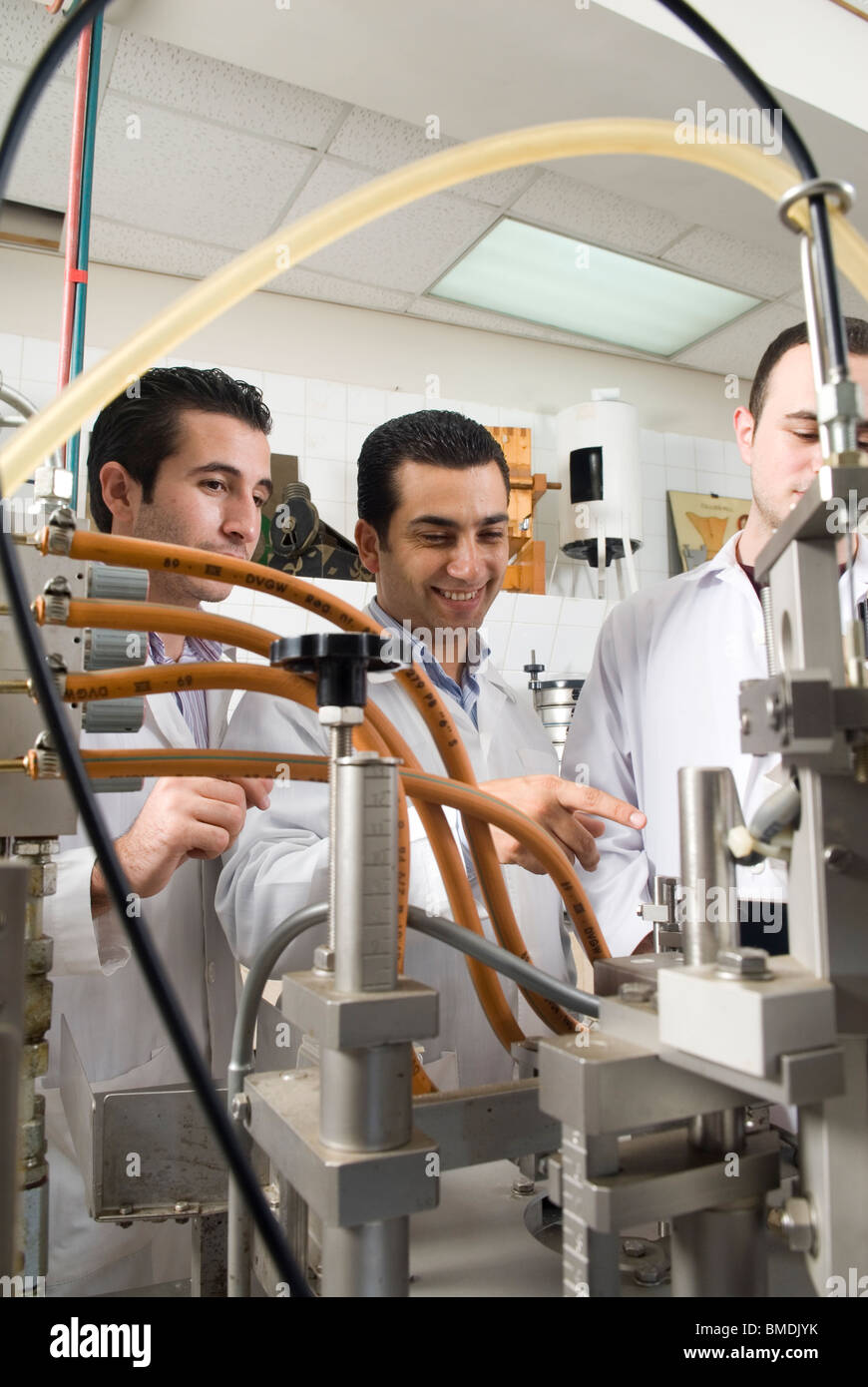 Middle Eastern scientists operating pharmaceutical machine inside lab Beirut Lebanon Middle East Stock Photo