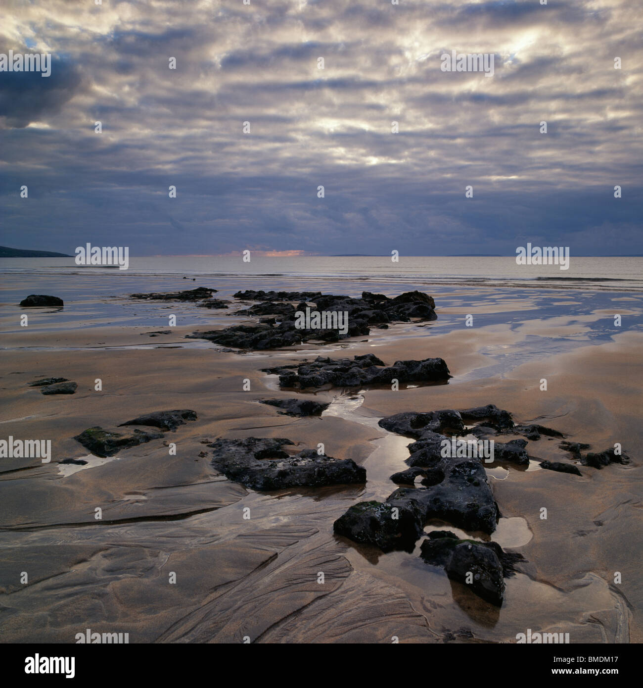 Moody sunset on the beach Stock Photo - Alamy