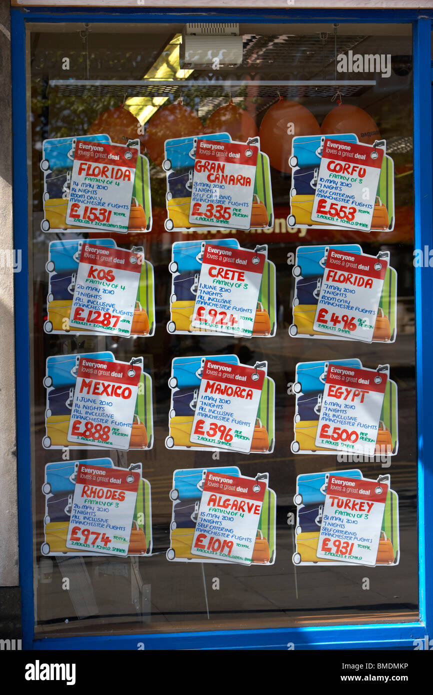 late deals and offers in the shop window of a travel agent in england uk Stock Photo