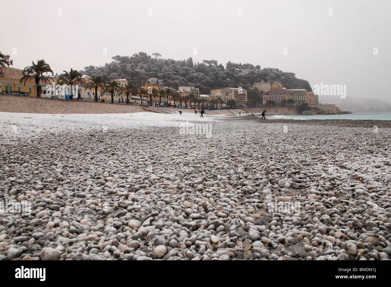 Snowed beach in winter time in Nice city. Snow in French Riviera is rare and  happen approximately every 10 years. Stock Photo