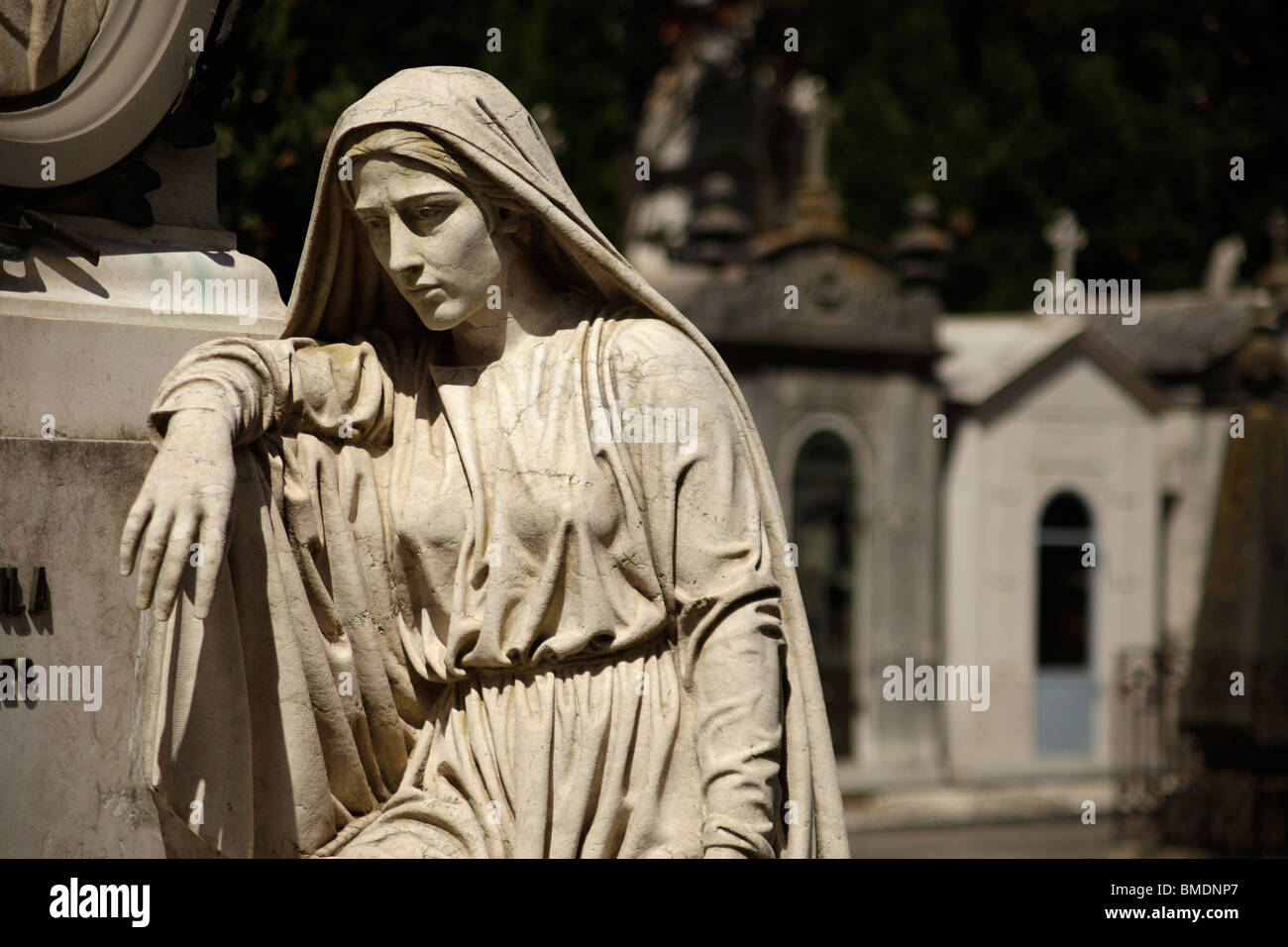 statue of a Mourning woman on a grave at Prazeres Cemetery in Lisbon, Portugal, Europe Stock Photo
