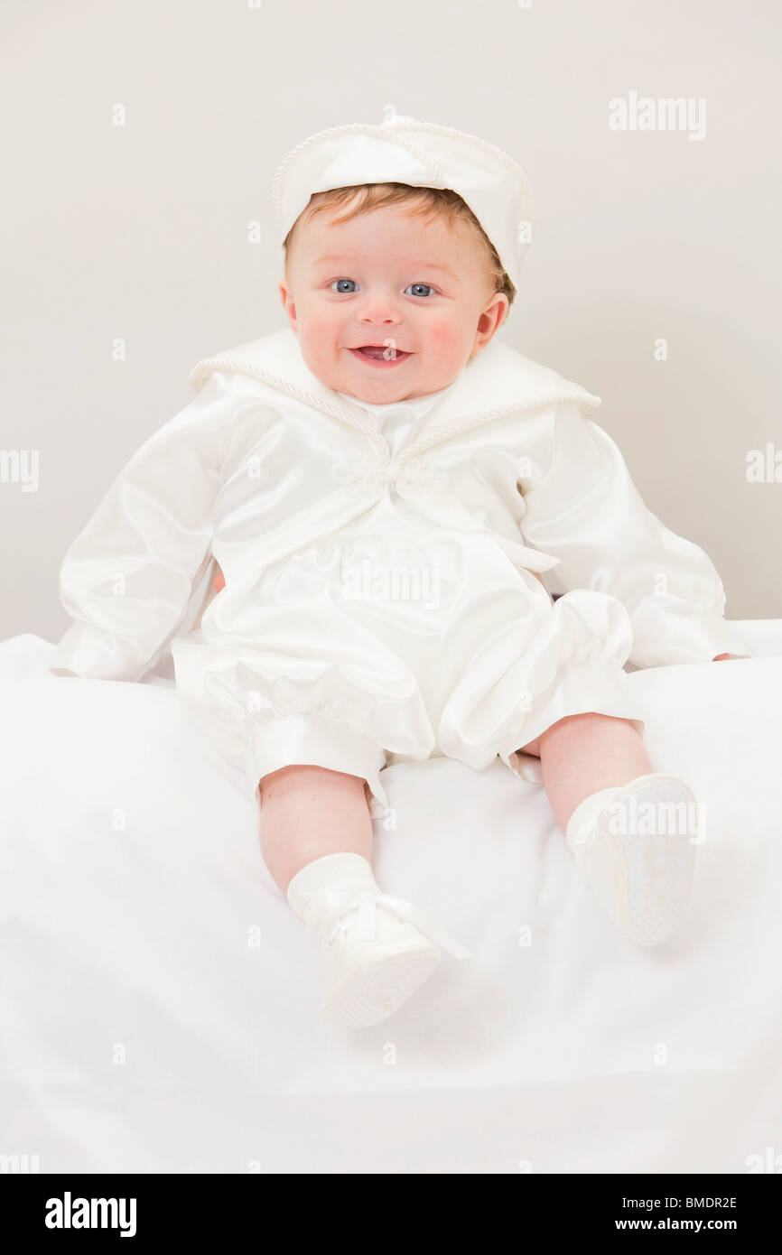 A baby boy wearing traditional Christening clothing Stock Photo Alamy