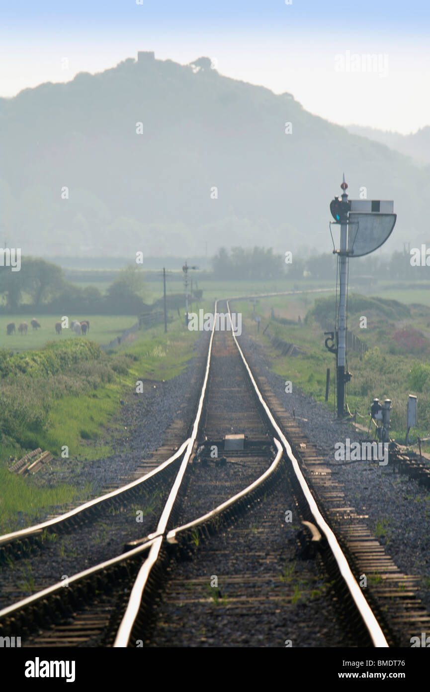 A train on a railway line in the countryside Stock Photo - Alamy
