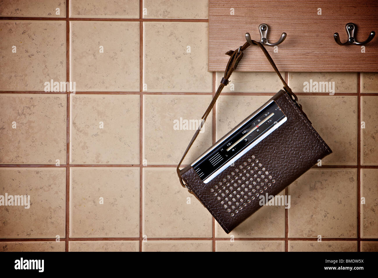 FM radio receiver in the retro style hanging on tiled wall Stock Photo -  Alamy