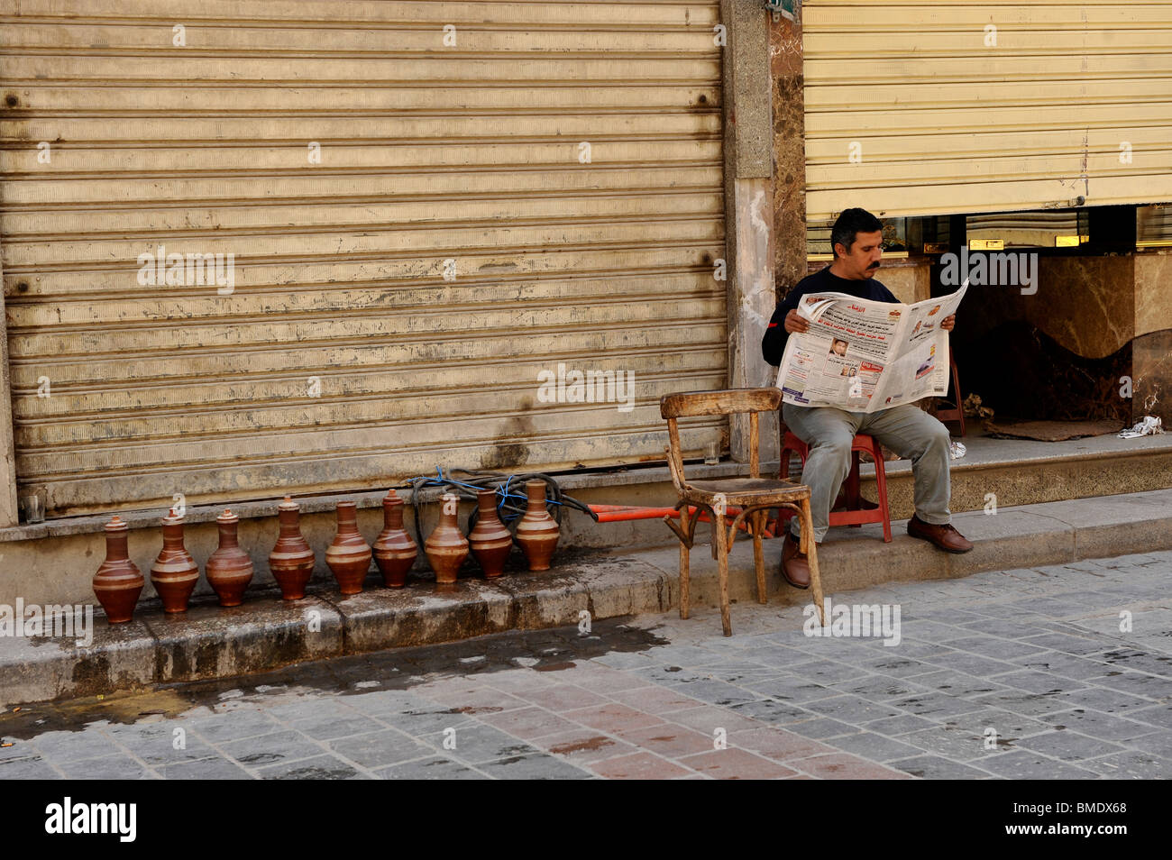 egyptian reading newspaper , back streets of the old district,Al