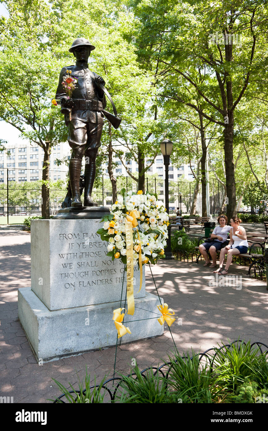 fresh wreath inscribed Flanders Remembers placed informally by Flemish group in front of bronze WW1 soldier statue NYC park Stock Photo