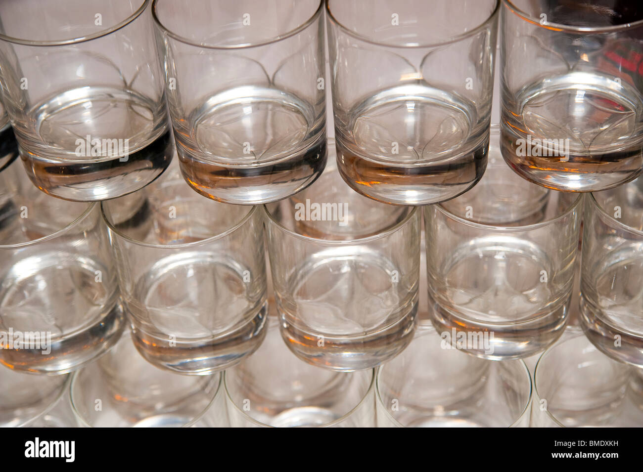 Empty water glasses lined up in rows Stock Photo
