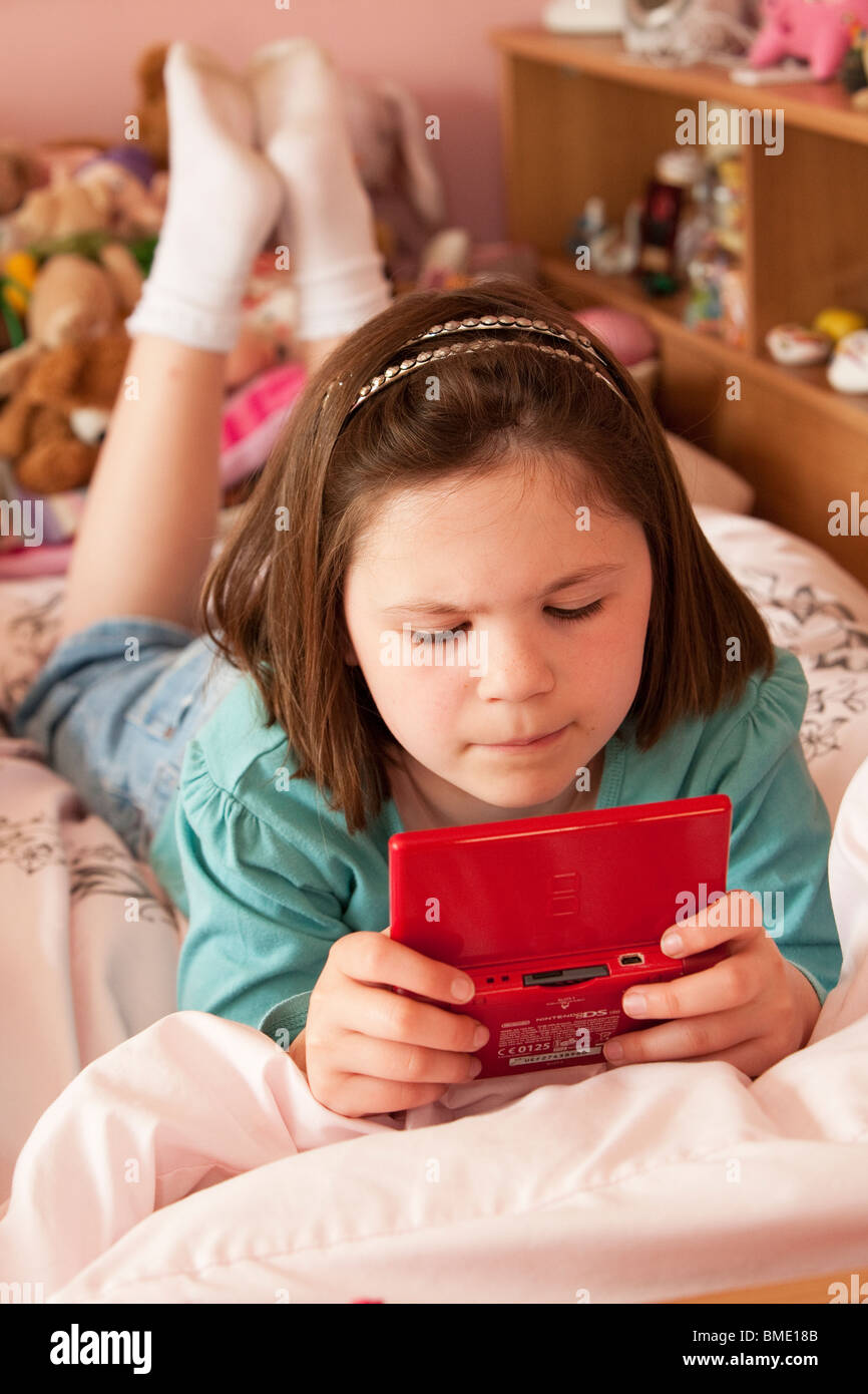 Girl playing nintendo lying on hires stock photography and images Alamy