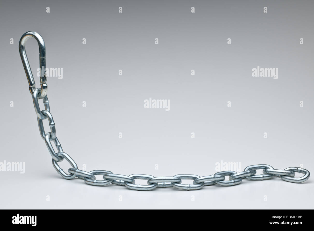 A hanging strong metal chain and clip Stock Photo
