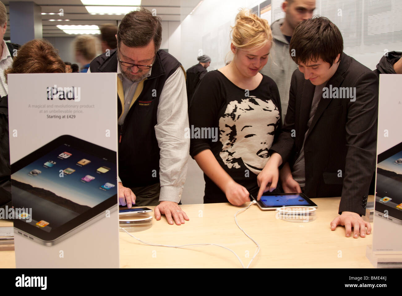People using iPad - Apple Store - Regents Street - London Stock Photo