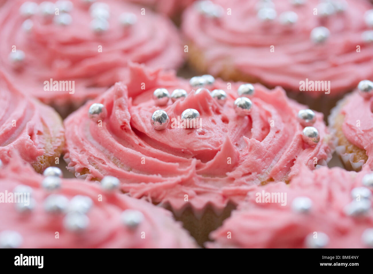 An array of decorated fairy cakes with a very shallow depth of field Stock Photo