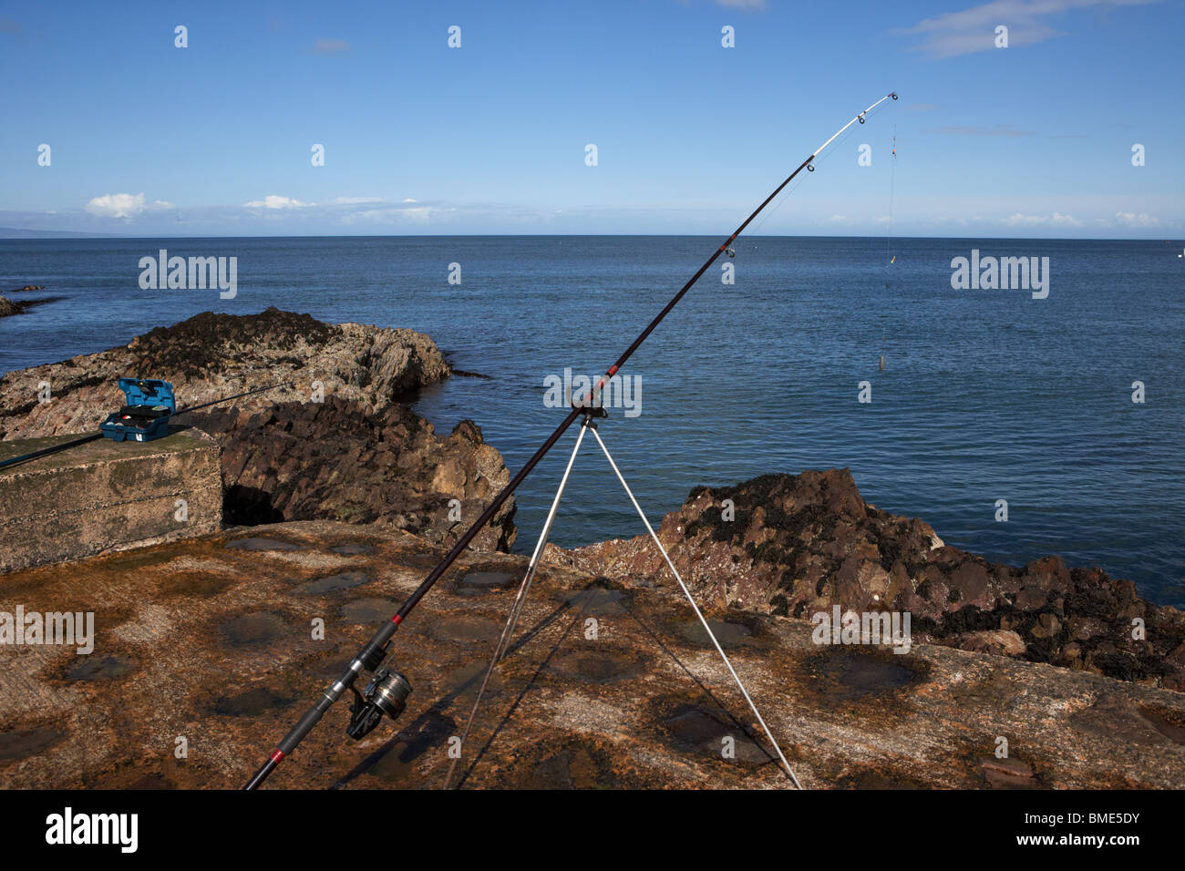 rod reel and tripod fishing on the county antrim coast northern ireland uk Stock Photo