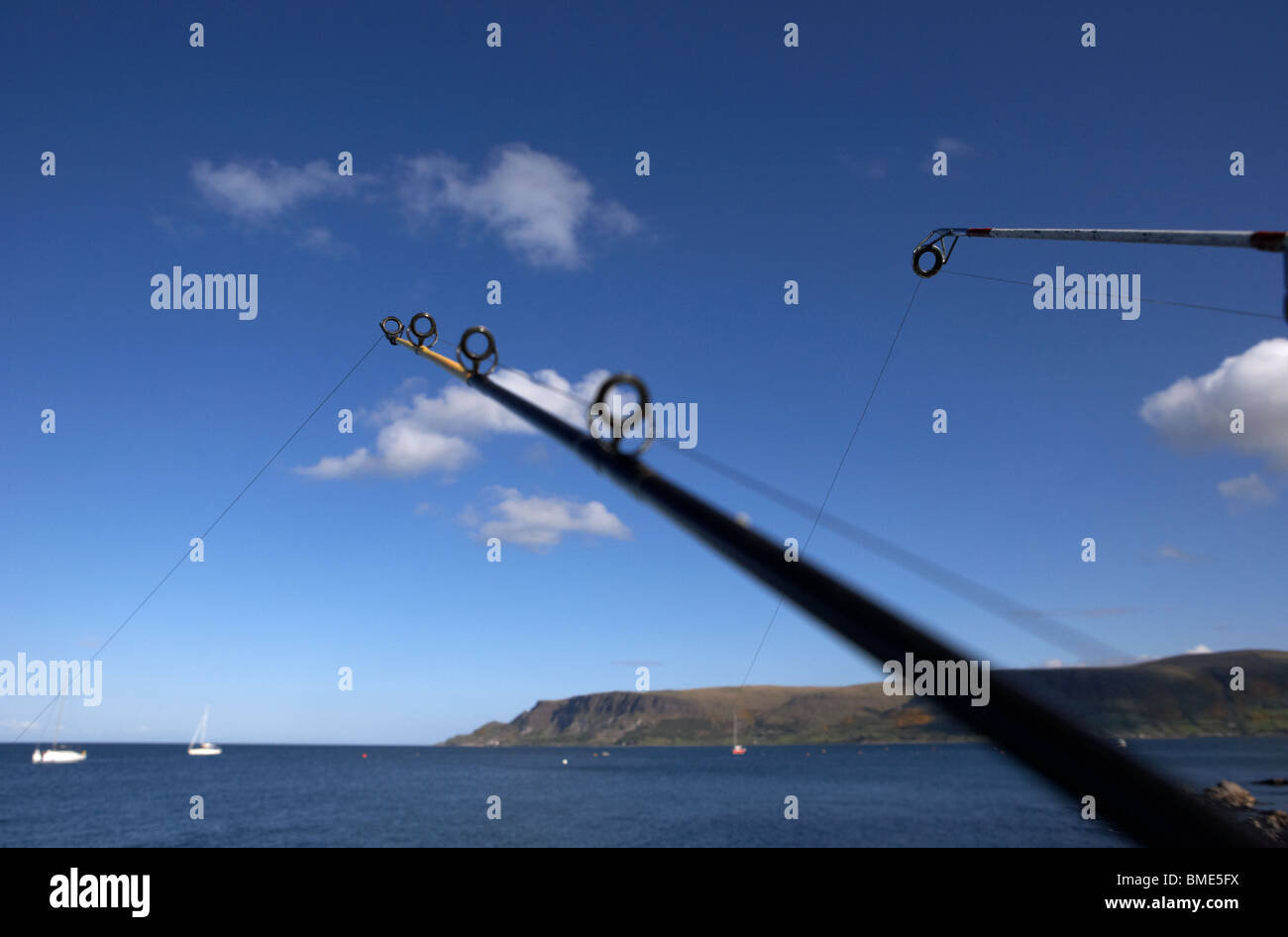 two rods fishing on the county antrim coast northern ireland uk Stock Photo