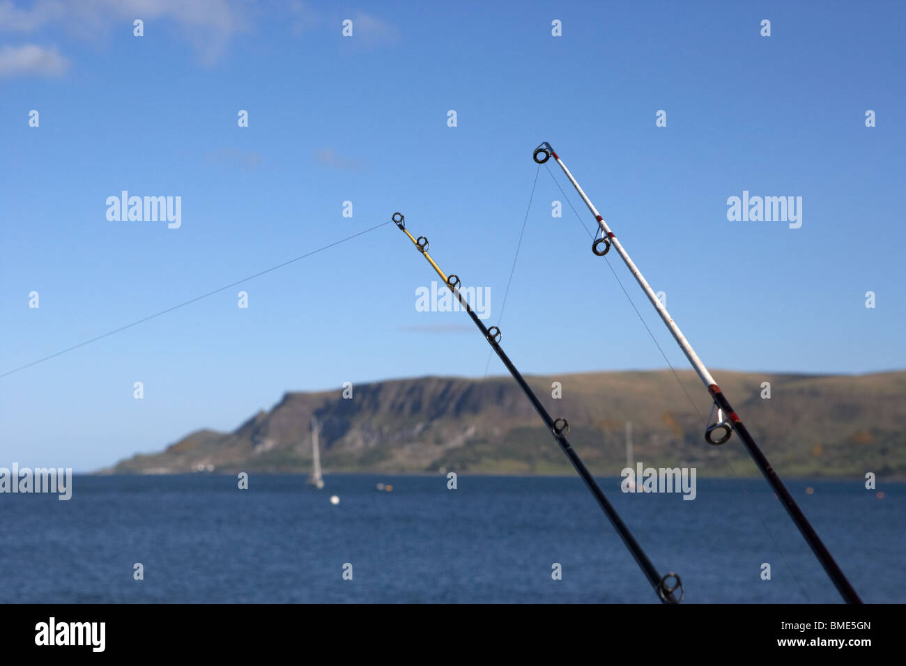 two rods fishing on the county antrim coast northern ireland uk Stock Photo