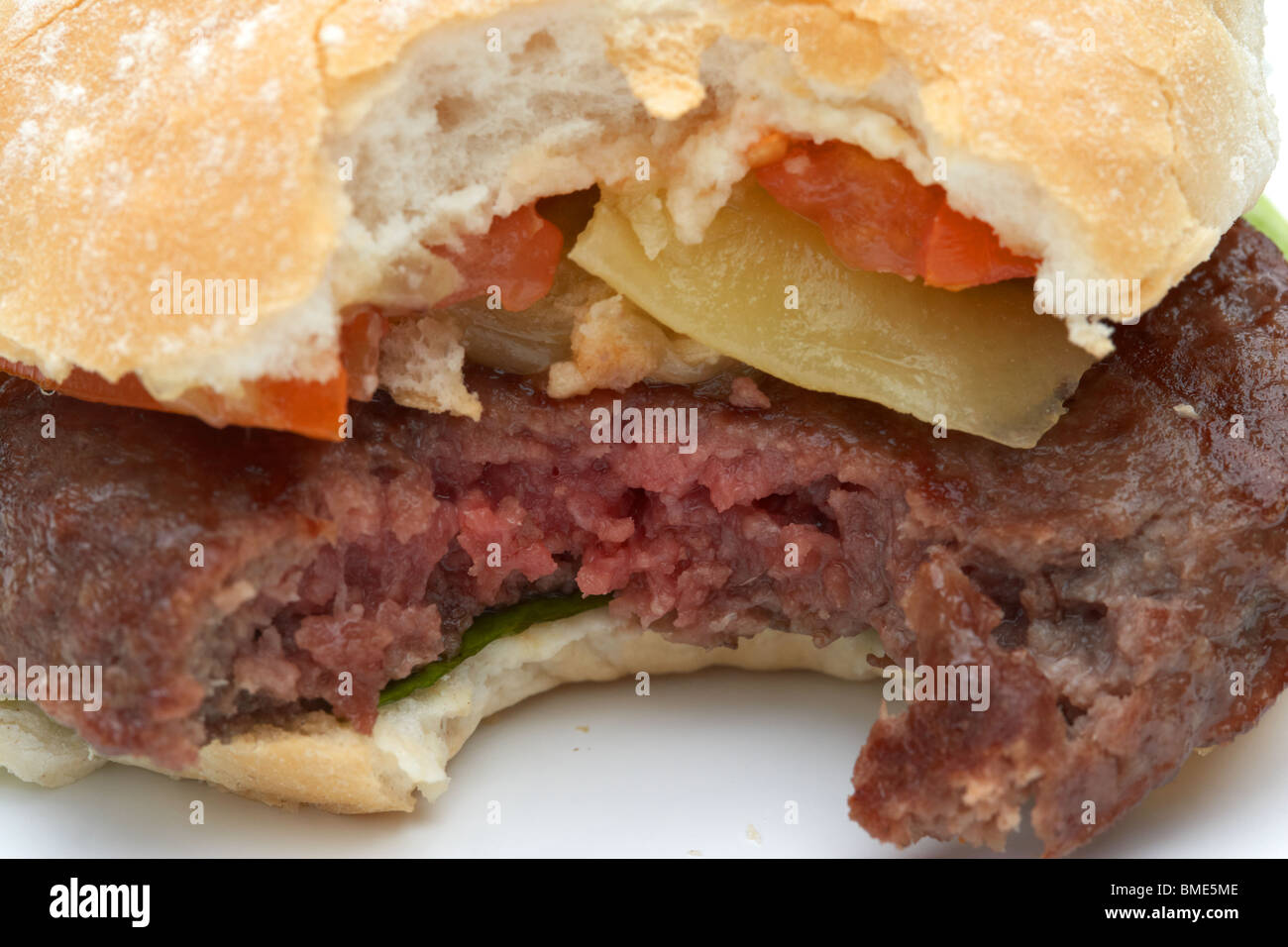 Bite Taken Out Of Partially Cooked Home Made Hamburger Showing Raw Meat Stock Photo Alamy