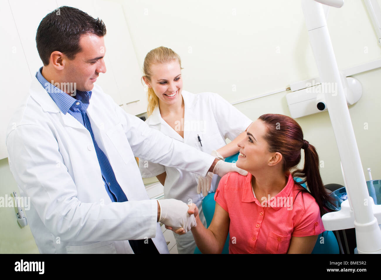 dentist or doctor congratulate patient for a successful operation Stock Photo