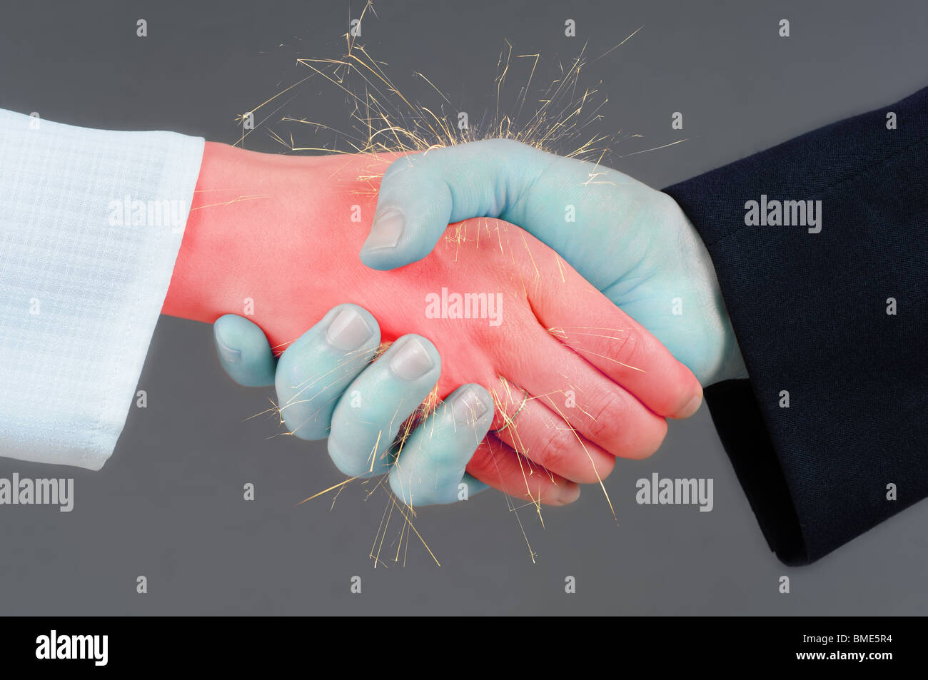 Handshake concept - clash of male and female hand. Stock Photo