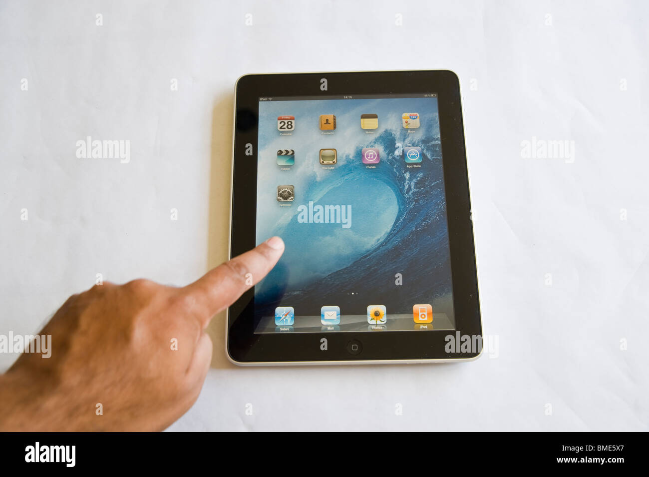 Man pointing at Apple iPad, Touchscreen Tablet Computer, Book Reader, Digital E book, Modern, Logo, Brand, Luxury Stock Photo