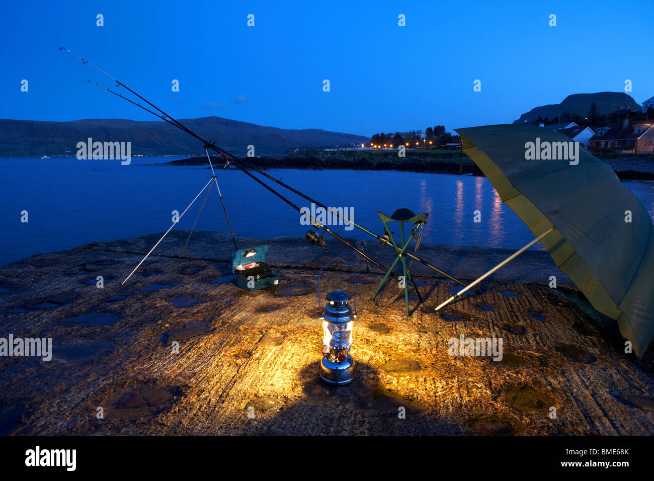nighttime fishing on the county antrim coast northern ireland uk Stock Photo