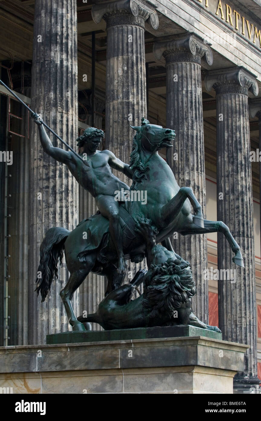 Statue of a man riding a horse fighting a lion outside the Altes Museum Berlin Germany Stock Photo