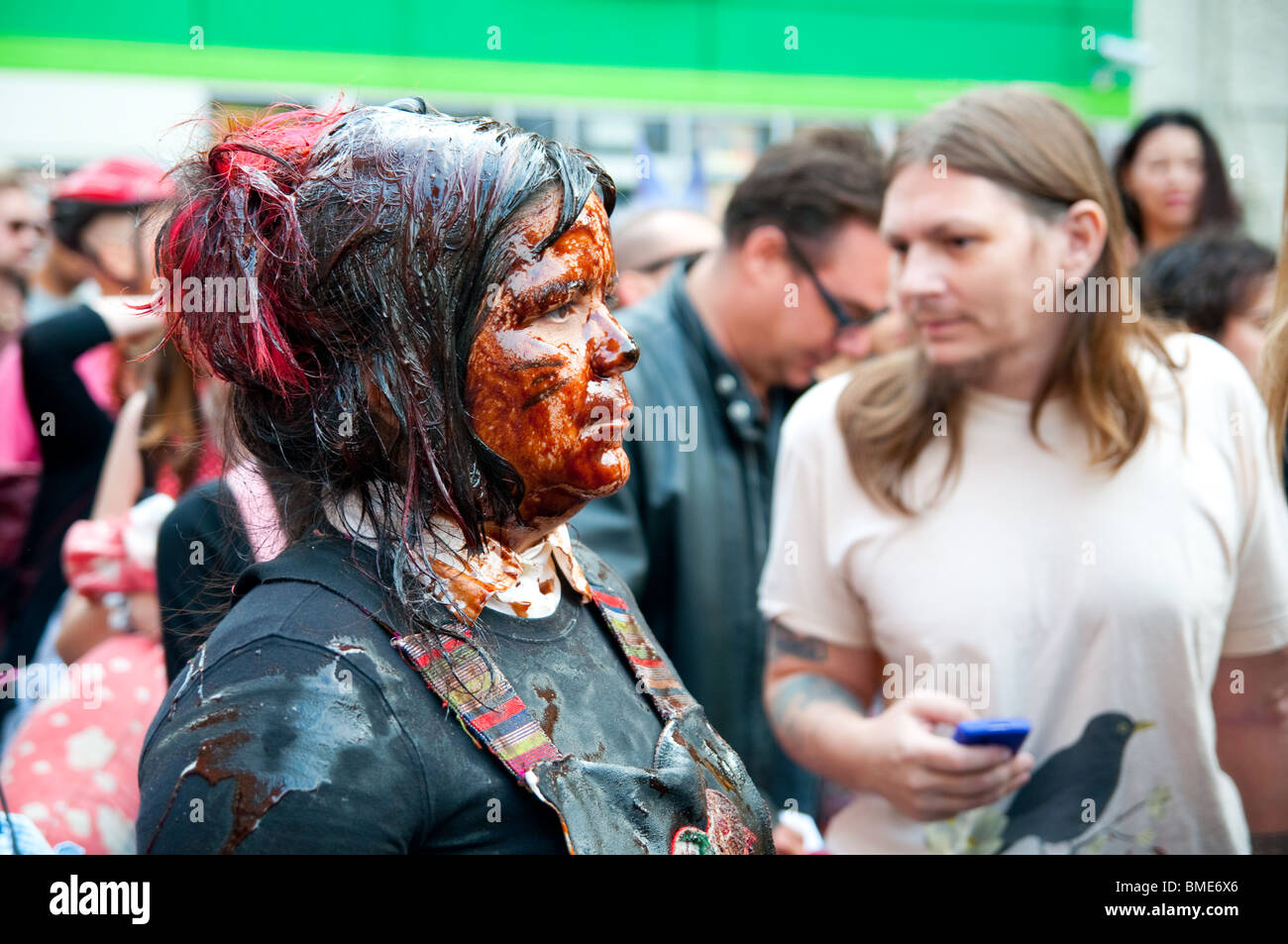 Female Activist douses herself in 'oil' in Soho, New York, to protest BP's disastrous oil spill.  May 28, 2010. Stock Photo