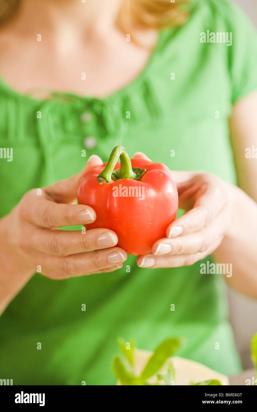 Woman holding a pepper, Sweden. Stock Photo