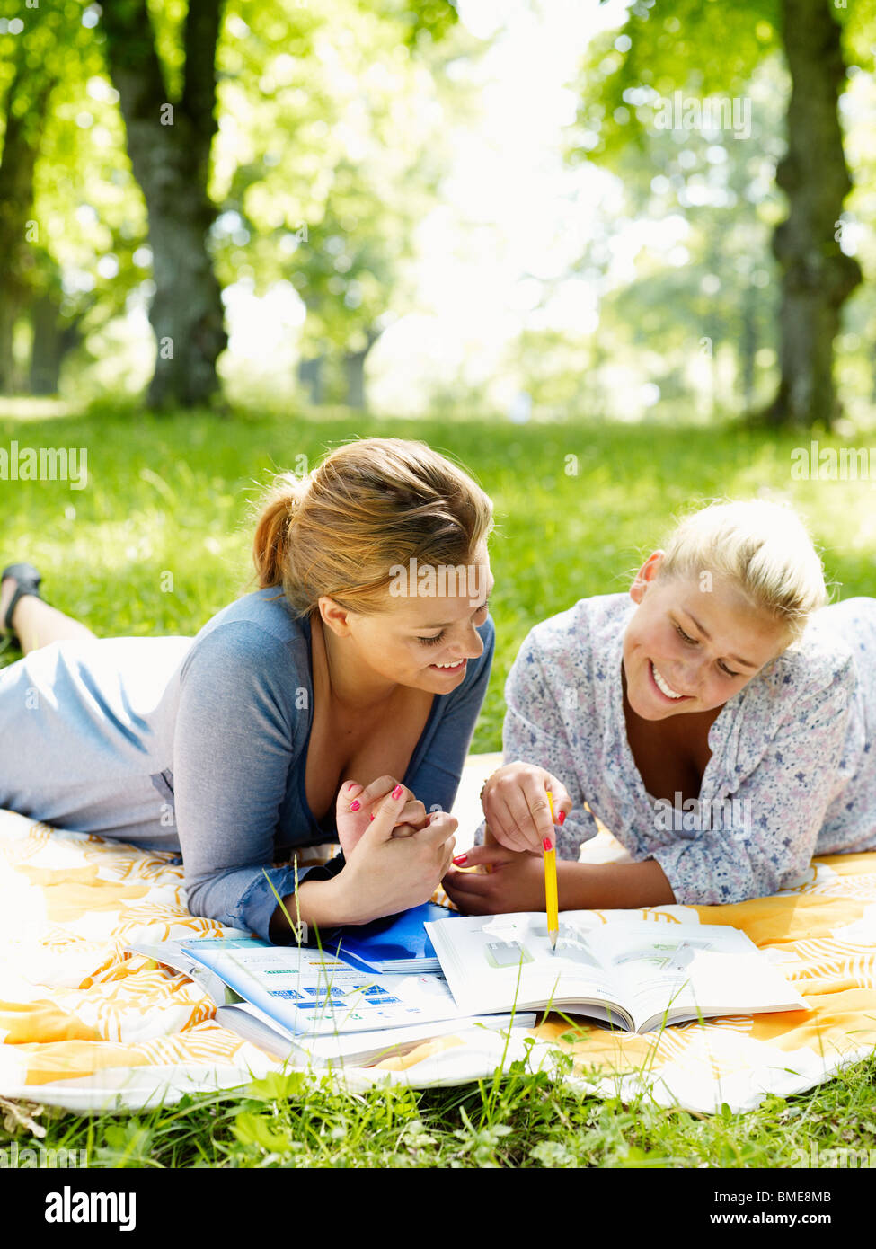 Women lying on blanket and learning Stock Photo