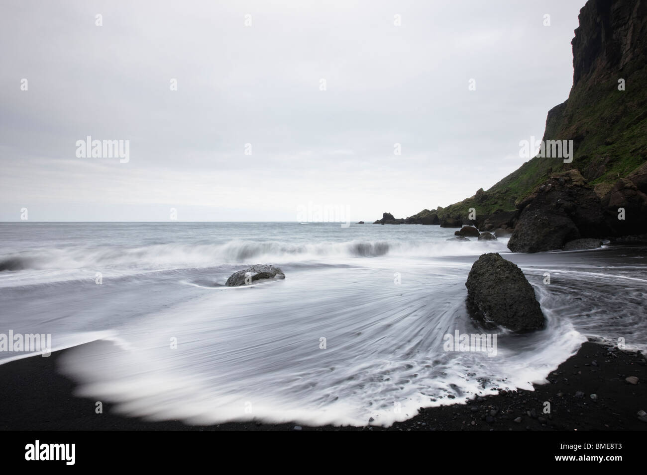Sea water washing over black rocks hi-res stock photography and images ...