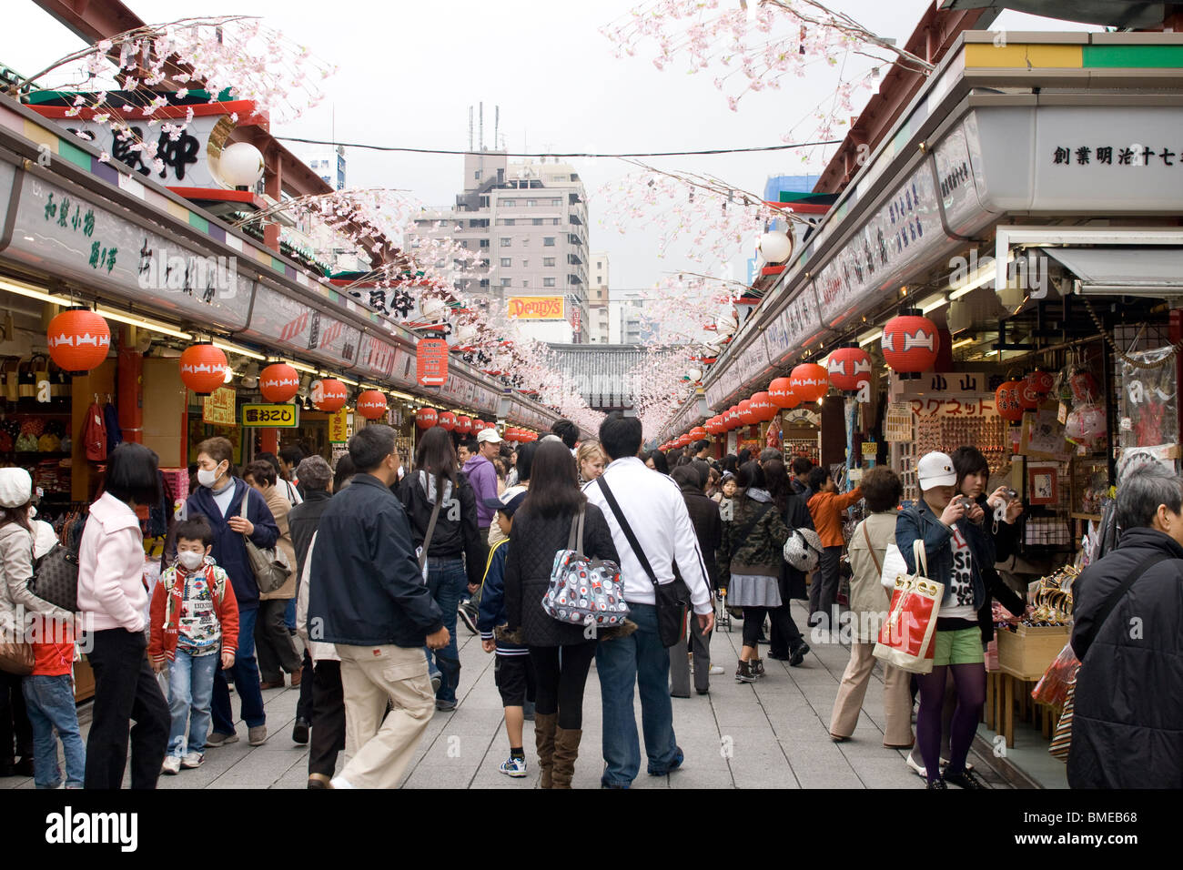 Visitors to the Asakusa Kannon Temple walking through the street with tourist shops in  Tokyo, Stock Photo