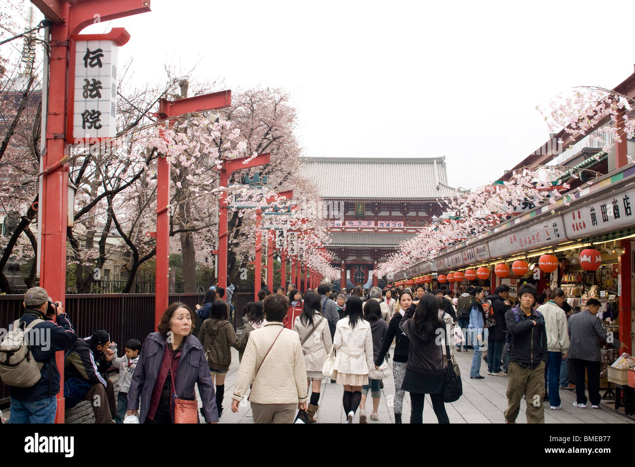 Visitors to the Asakusa Kannon Temple walking through the street with tourist shops in  Tokyo, Stock Photo
