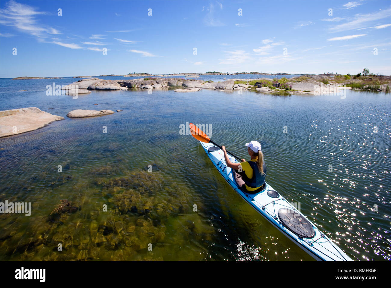 Woman kayaking in sea Stock Photo