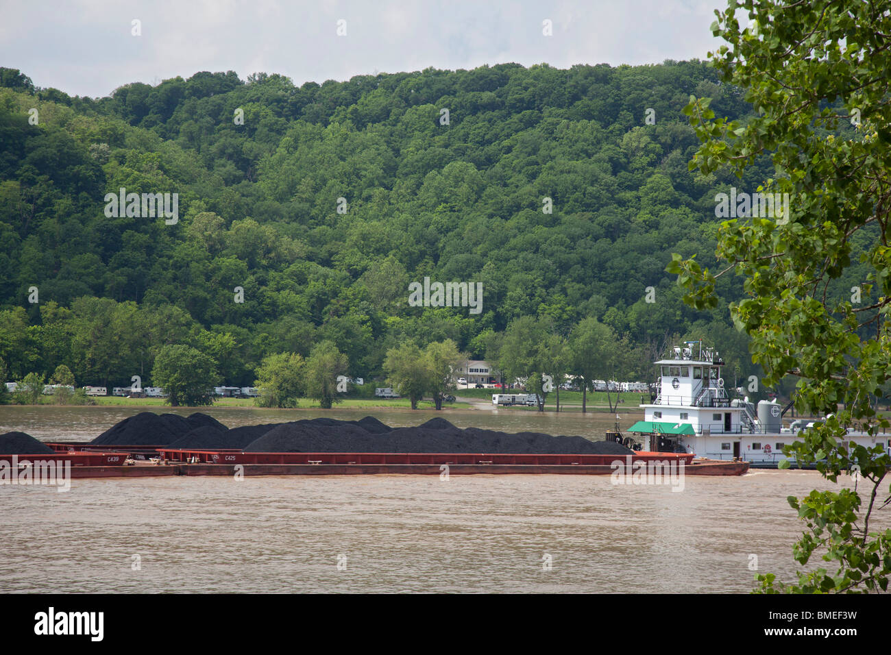 Madison, Indiana - A tugboat pushes barges loaded with coal upstream on the Ohio River. Stock Photo
