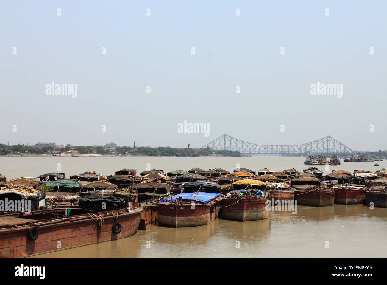 Boats on the Hooghly River, Calcutta, with the Howrah Bridge in the background. Stock Photo