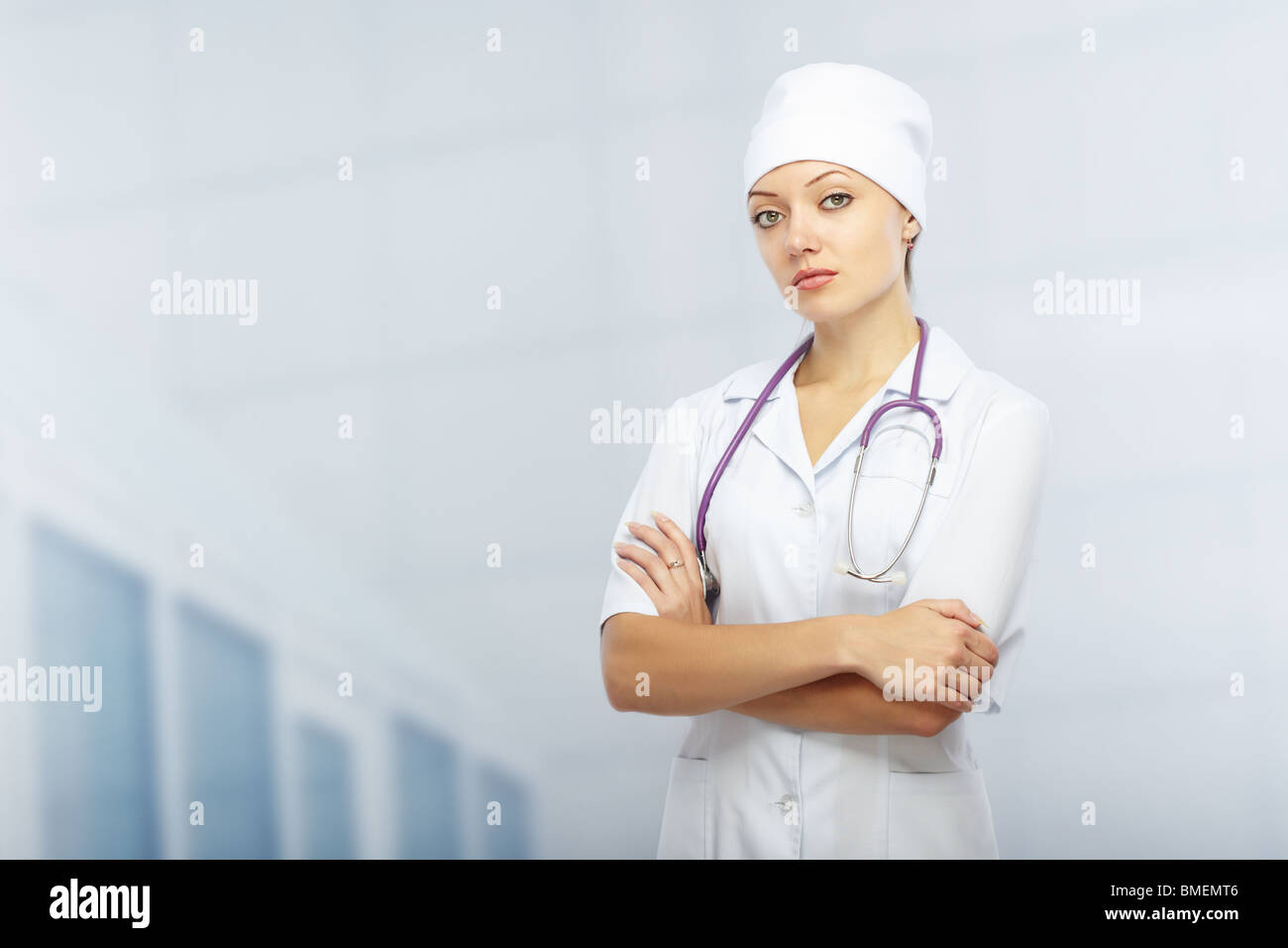 Cross-armed doctor with stethoscope in clinic. Healthcare theme Stock Photo
