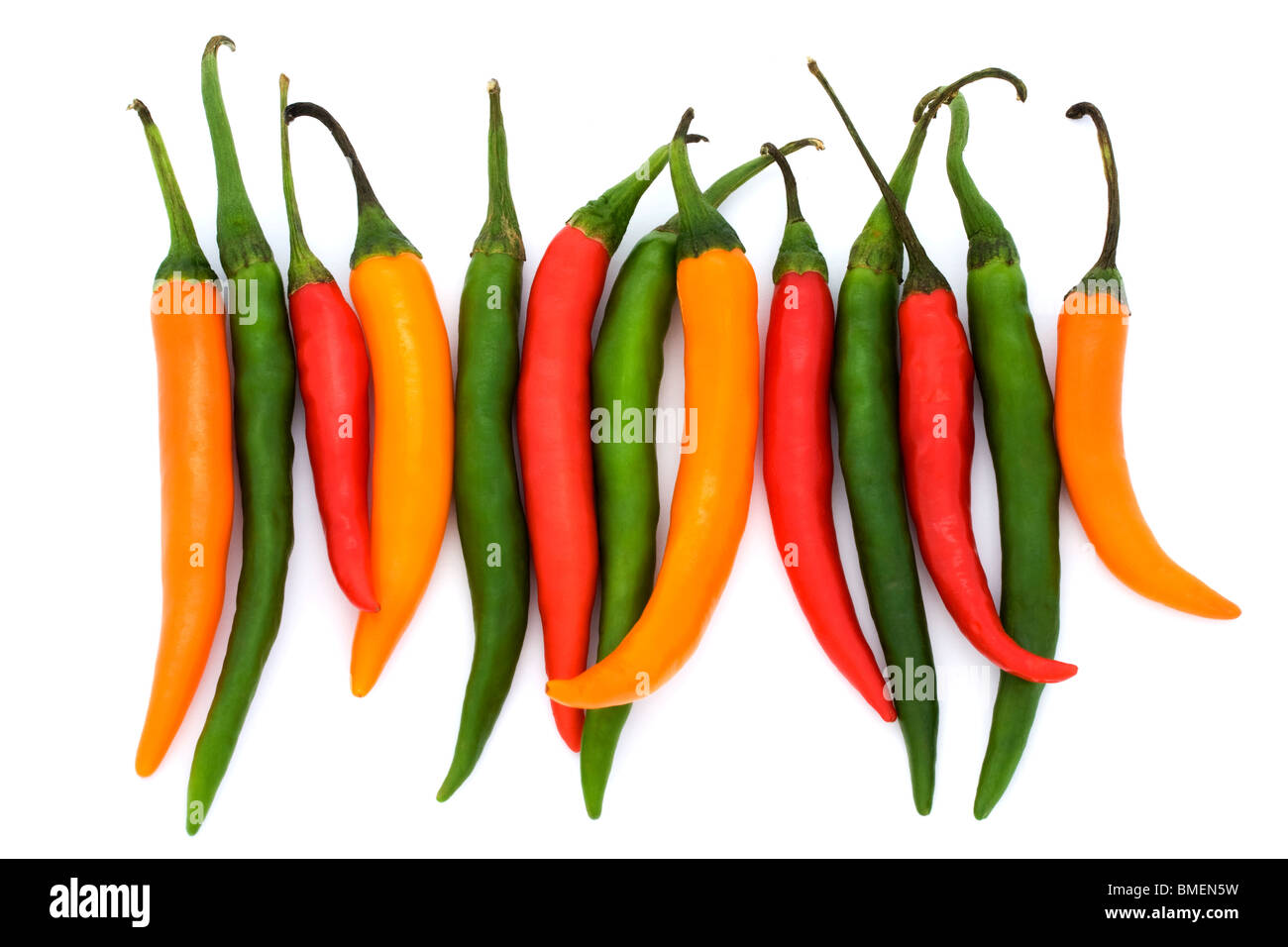 mixed coloured chilli peppers on a white background Stock Photo