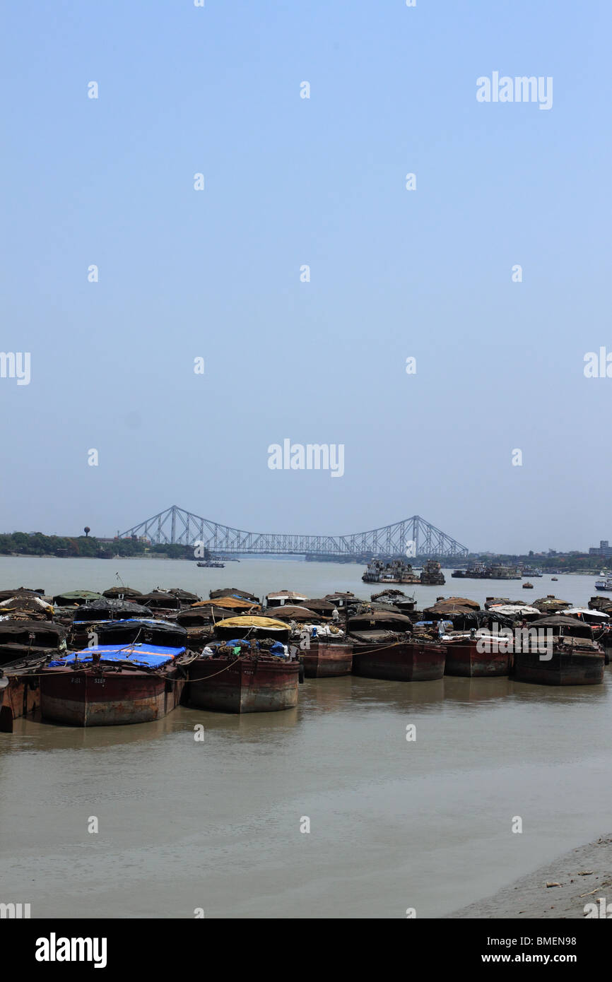 Boats on the Hooghly River, Calcutta, with the Howrah Bridge in the background. Stock Photo